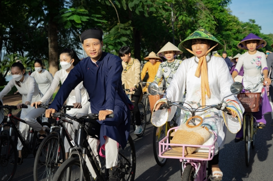 Locals and tourists in Ao Dai at a local festival